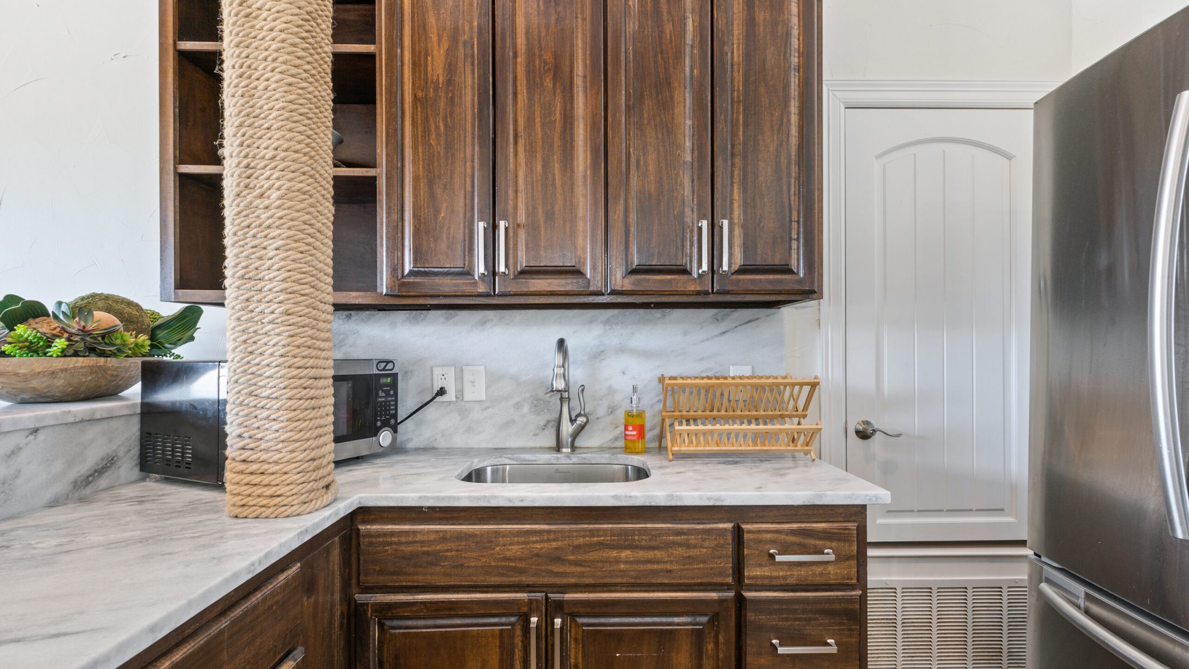 a kitchen with stainless steel appliances and wooden cabinets
