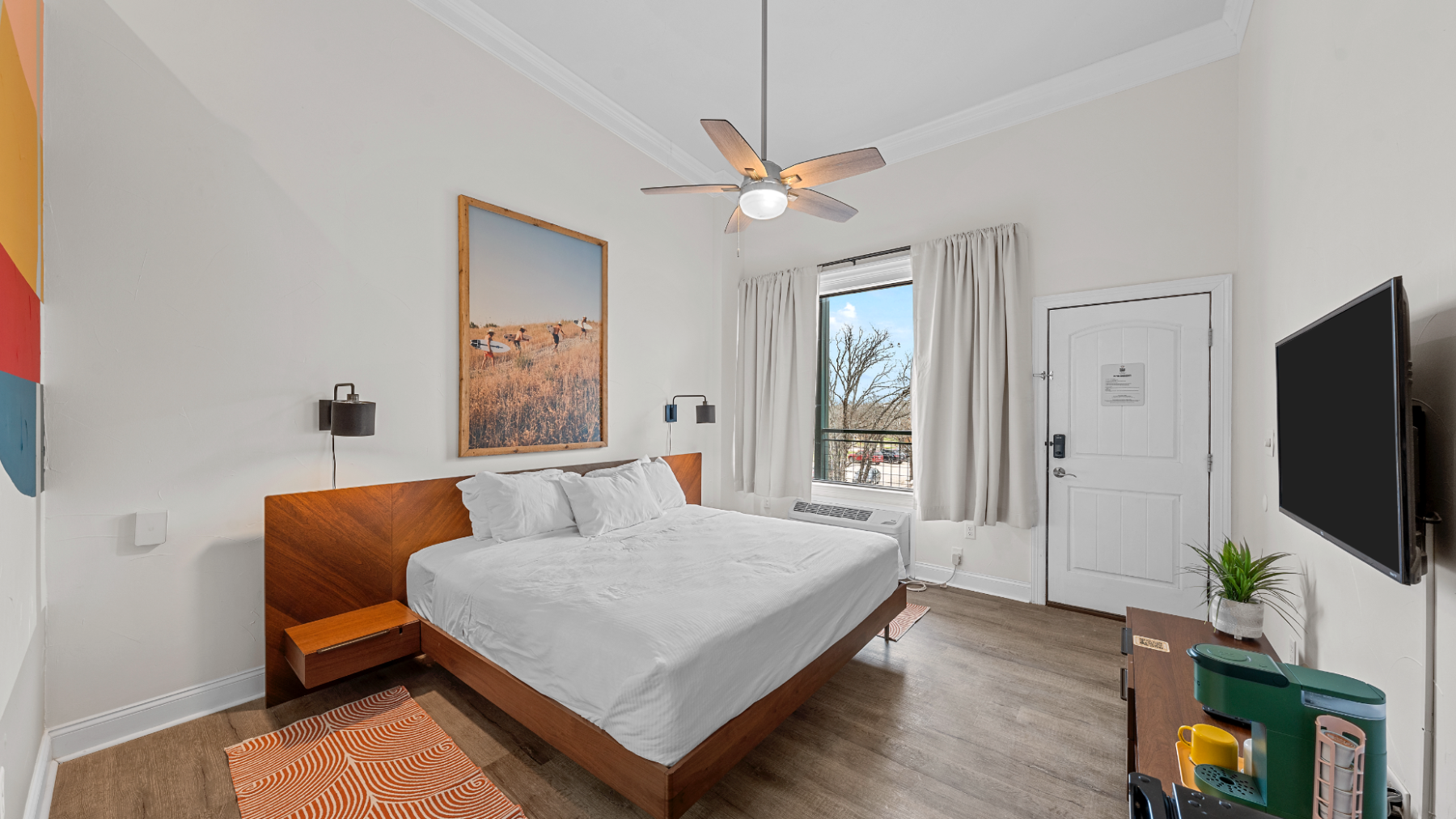 a bedroom with a bed and desk in a room