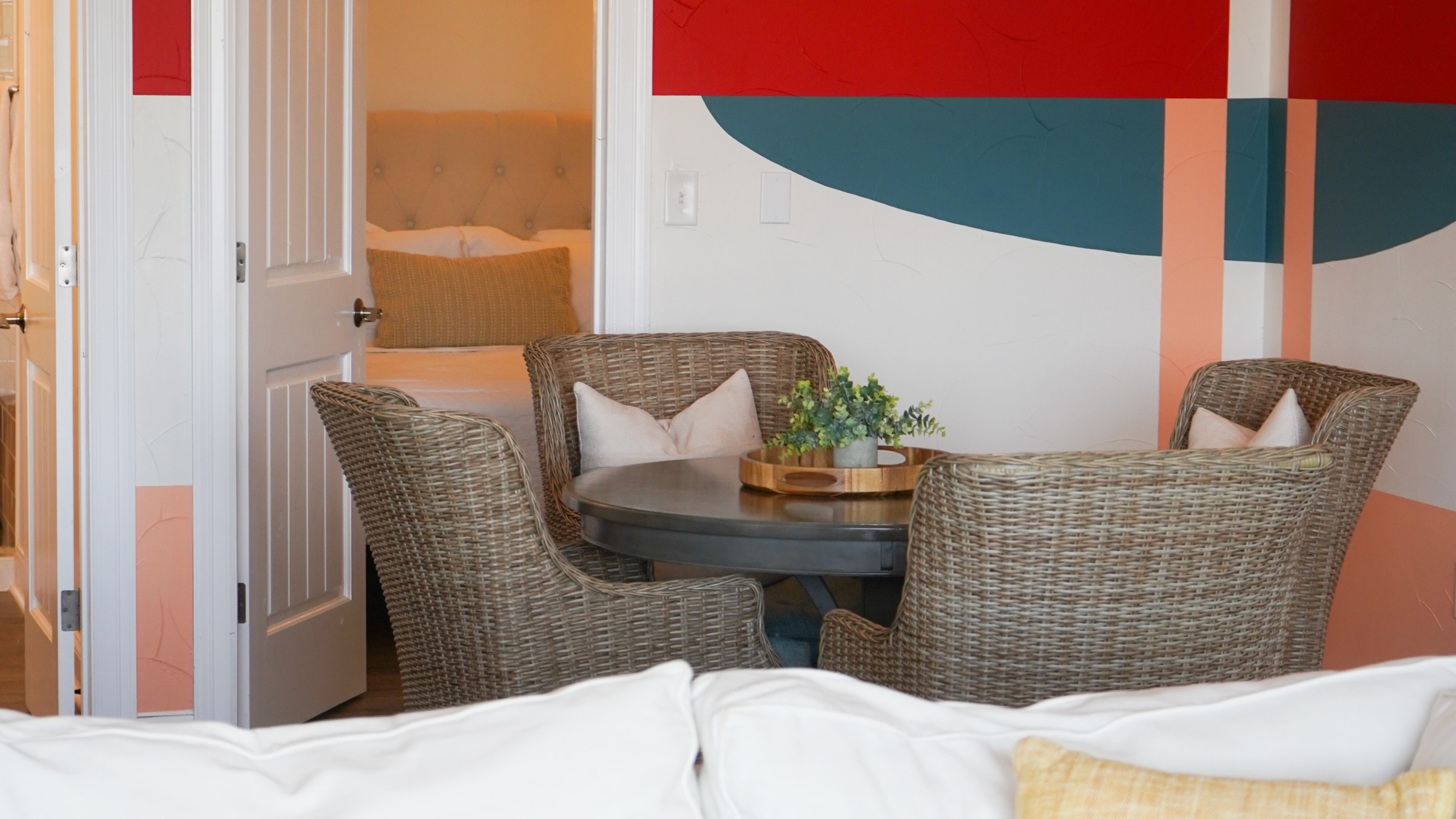 Dining table, sofa, and bedroom included in The Malibu Suite, a lodging option at Waco Surf