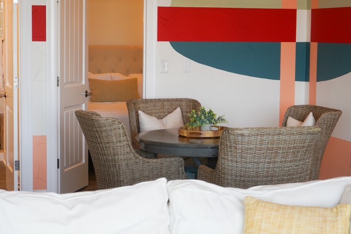 Dining table, sofa, and bedroom included in The Malibu Suite, a lodging option at Waco Surf