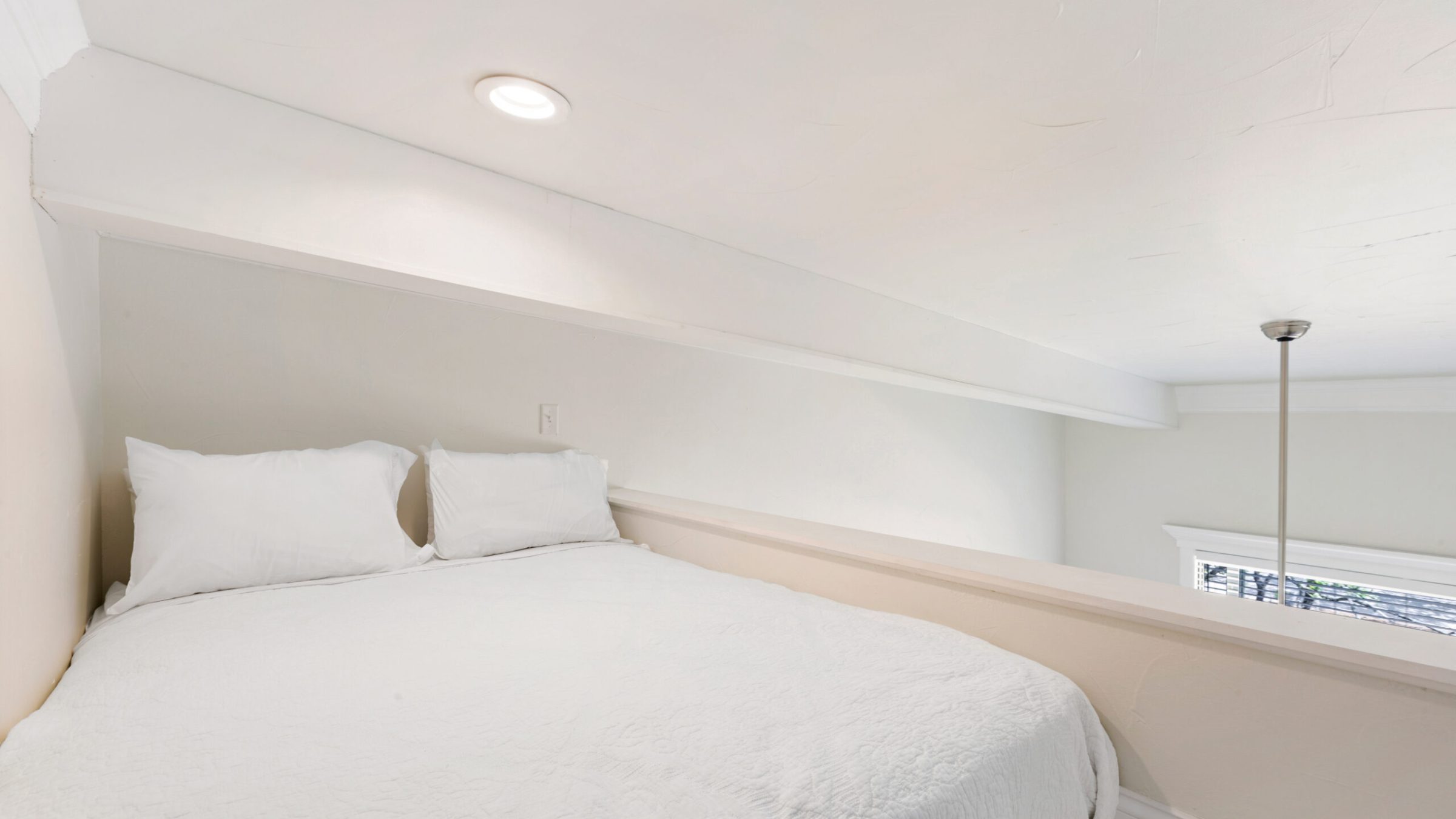 a bedroom with a bed in a room