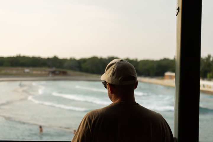 a man standing in front of water