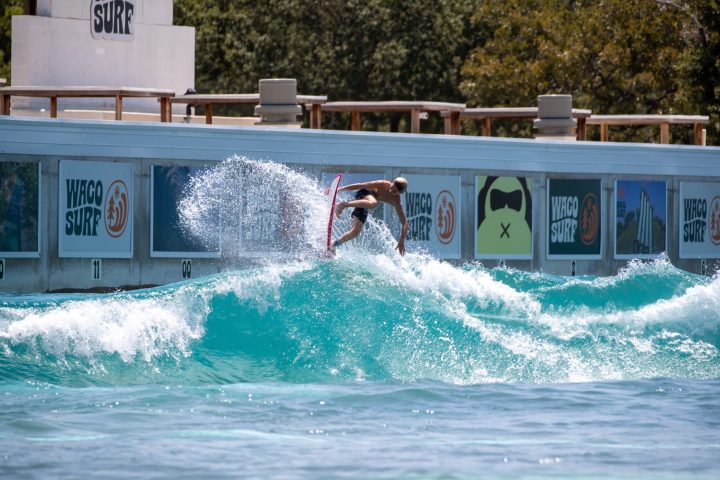 image of a surfer taking the pro surf session at waco surf a texas water park