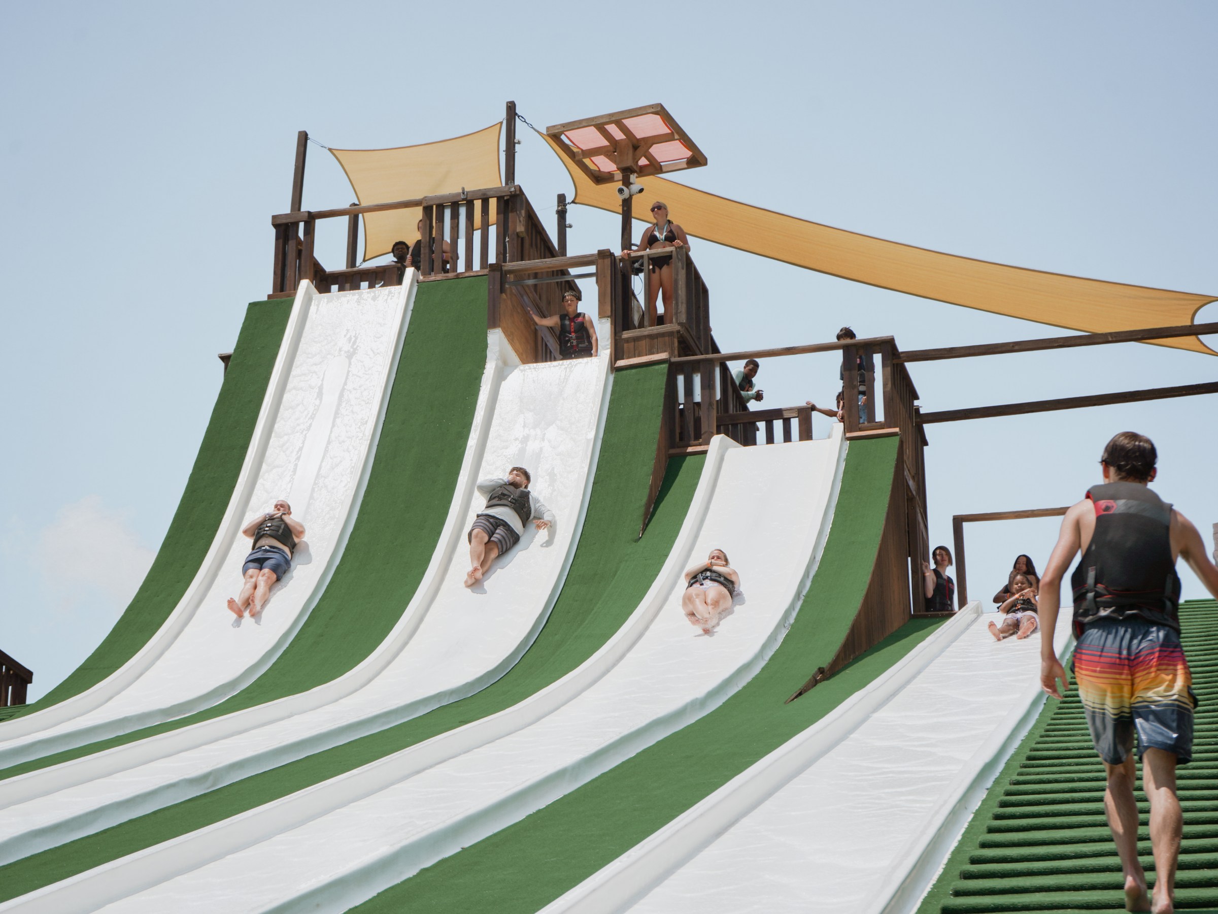 Guests going down the Wedge Slides at Waco Surf
