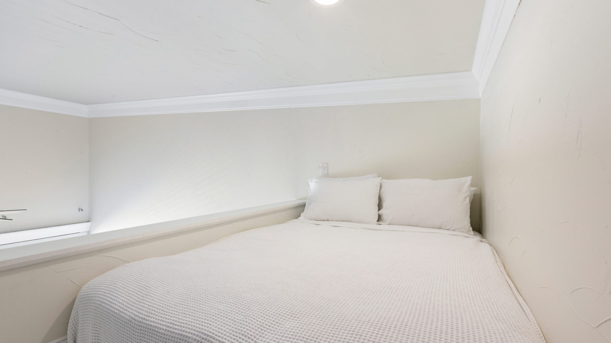 a bedroom with a bed in a room