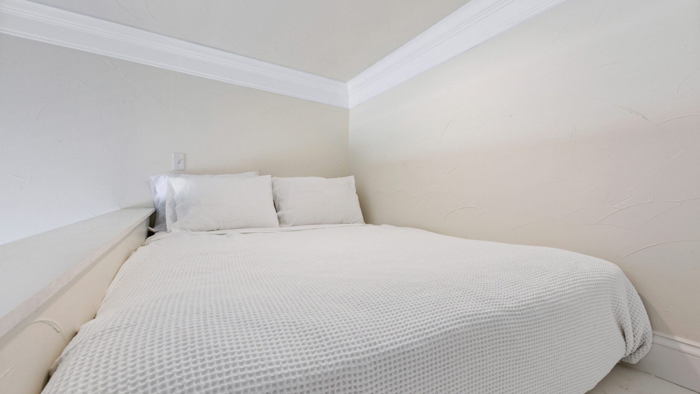 a bedroom with a bed in a room