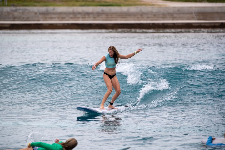 Woman surfing in Waco Surf beginner surf session