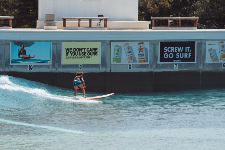 Woman surfing in Waco Surf beginner surf session